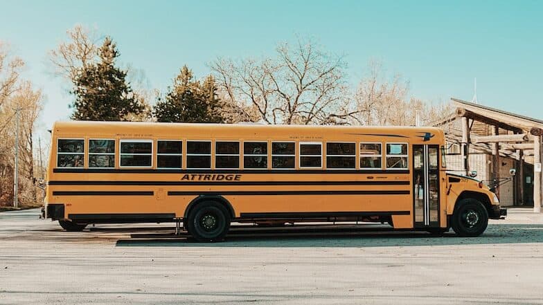 yellow bus on gray road